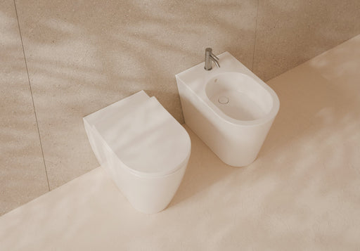 HIDE Round Back-to-Wall WC and bidet 57x37 in a bathroom setting – Alice Ceramica